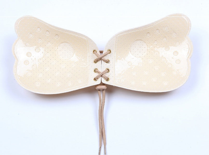 Model wearing nude strapless bra for seamless look under clothing