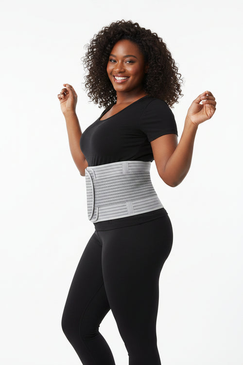 Gray waist trainer on a white surface with a small dish of cherries in the background.